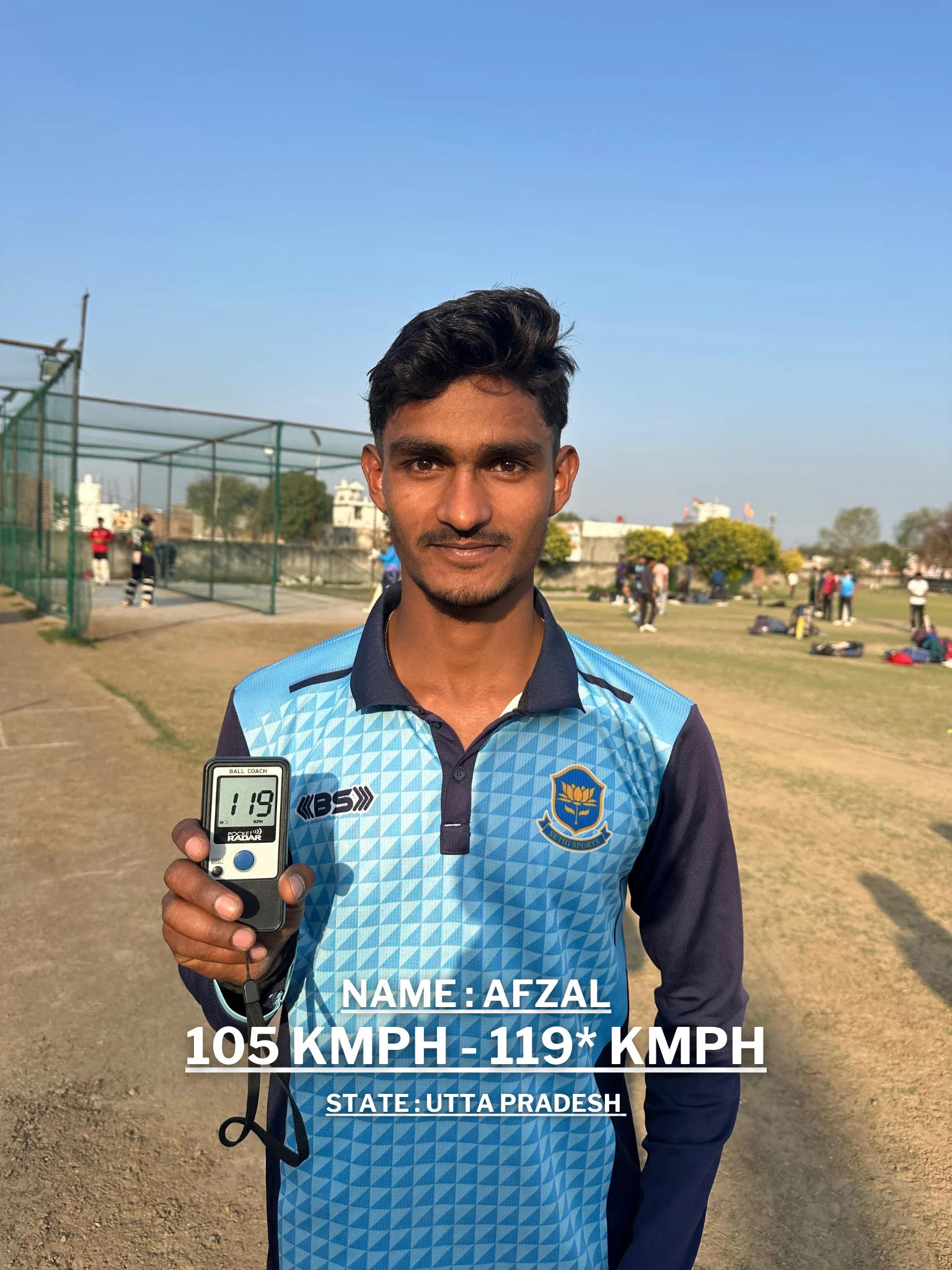 A young man is holding a cricket ball and a digital speedometer displaying his improved bowling speed at the Pathak100mph Cricket Academy.