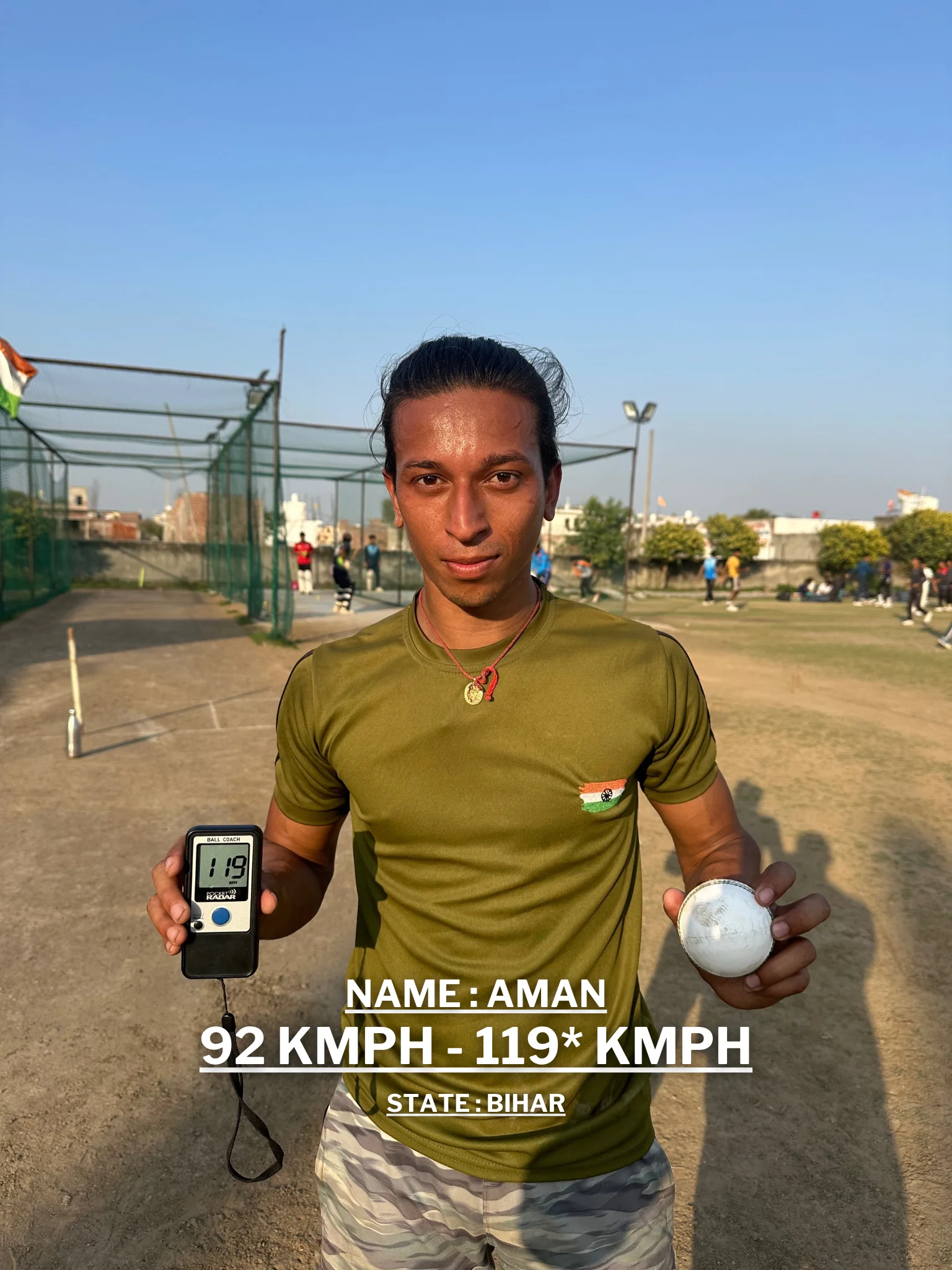 A young man is holding a cricket ball and a digital speedometer displaying his improved bowling speed at the Pathak100mph Cricket Academy.