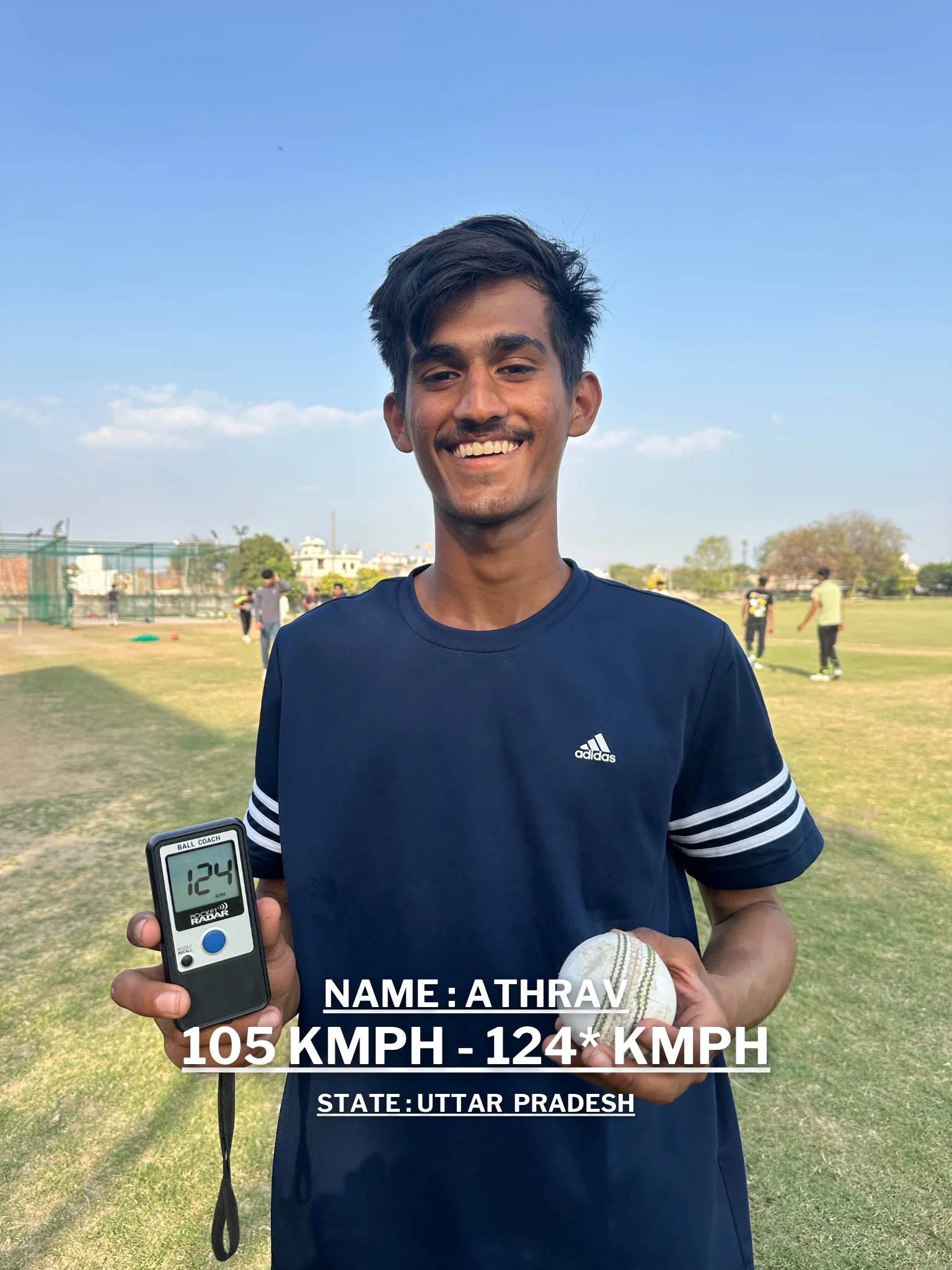 A young man is holding a cricket ball and a digital speedometer displaying his improved bowling speed at the Pathak100mph Cricket Academy.