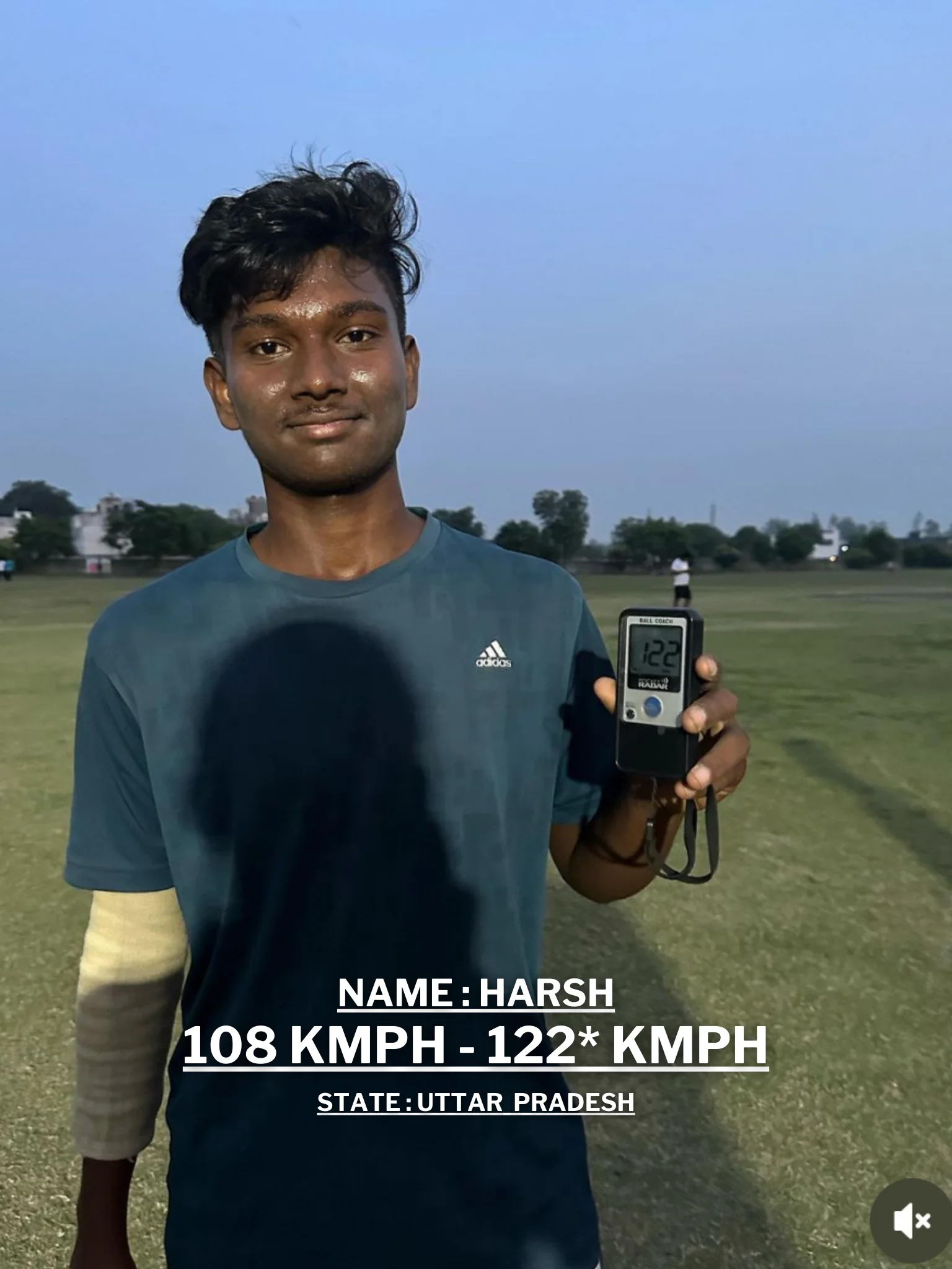 A young man is holding a cricket ball and a digital speedometer displaying his improved bowling speed at the Pathak100mph Cricket Academy.